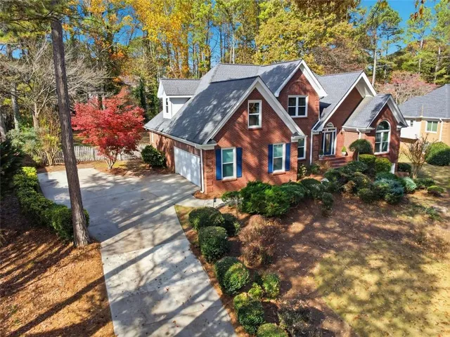 an aerial view of a house with a yard