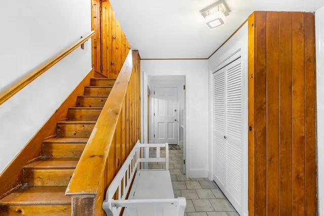 a view of entryway with stairs and door