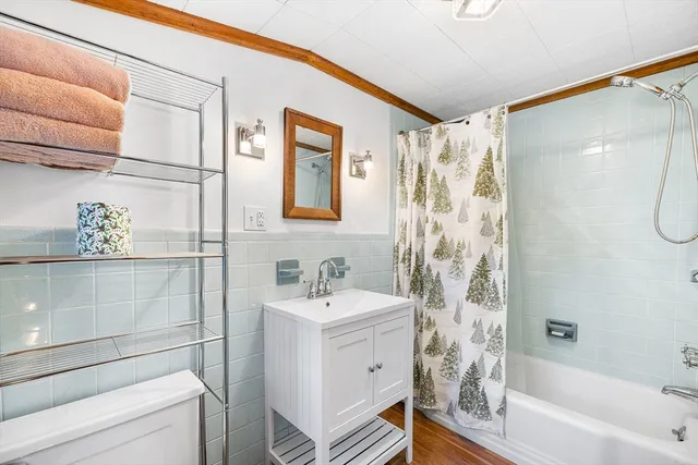 a spacious bedroom with a large bed and a chandelier