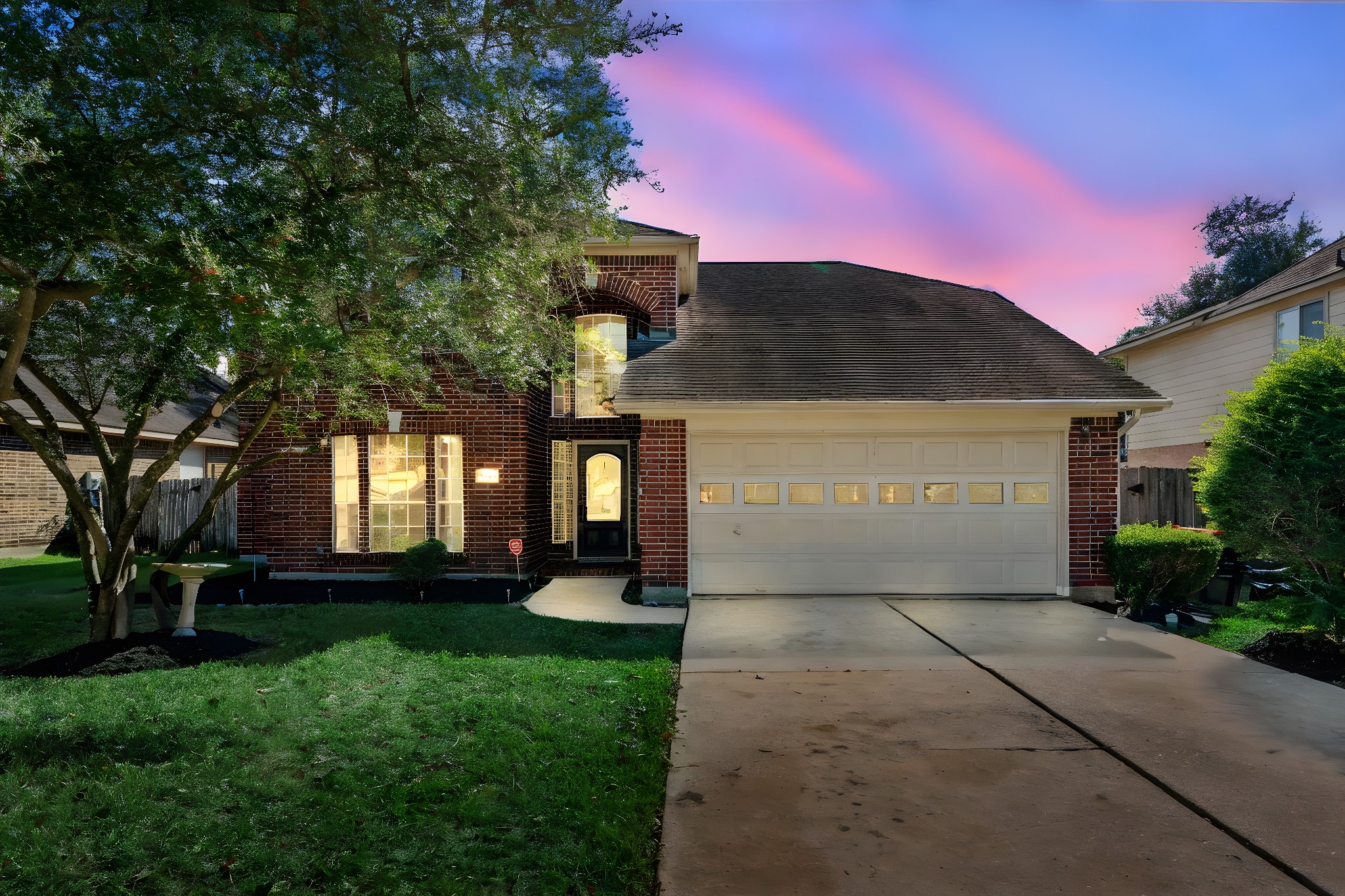 a front view of a house with a yard and a garage