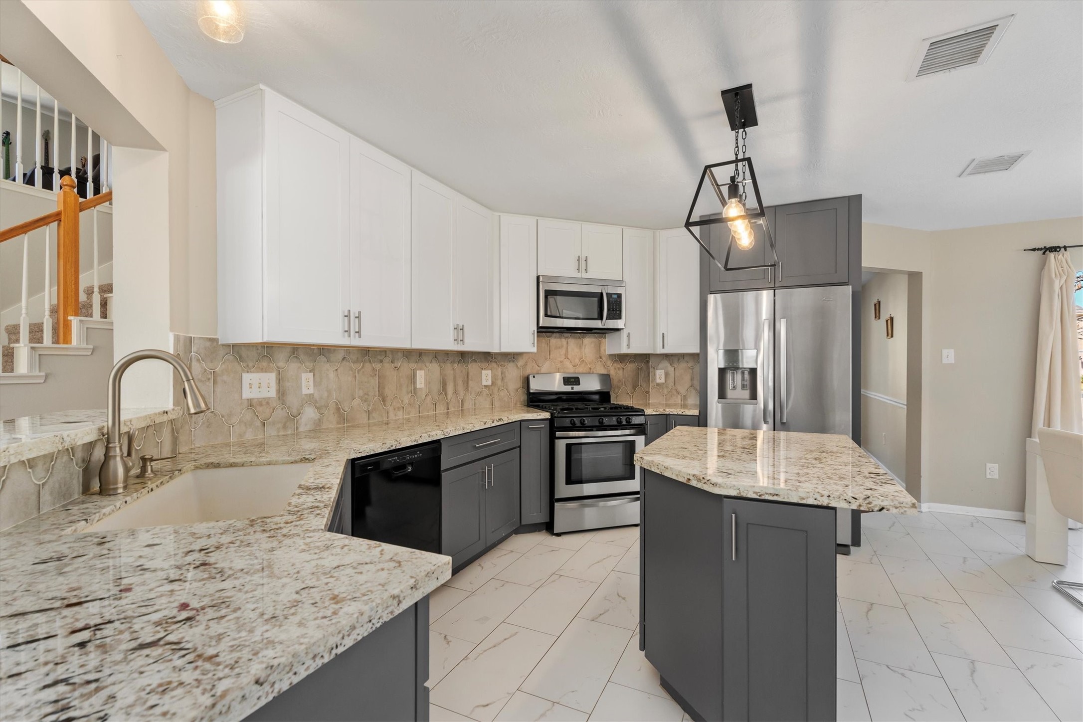 3315 La Seine Lane Spring, TX 77388 - Photo 12 of 30 a large kitchen with granite countertop a sink stainless steel appliances and cabinets