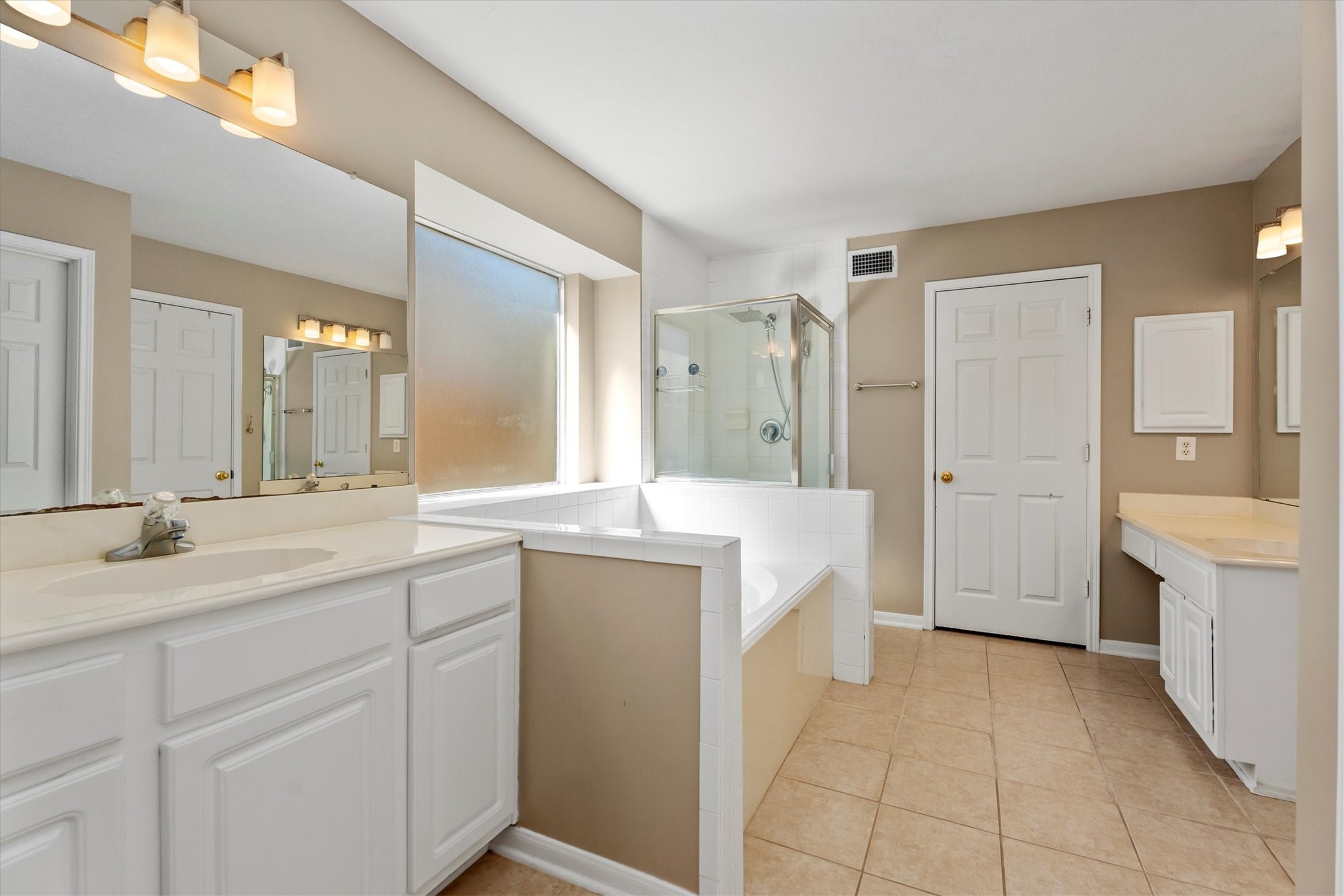3315 La Seine Lane Spring, TX 77388 - Photo 20 of 30 a spacious bathroom with a granite countertop sink a mirror and a bathtub
