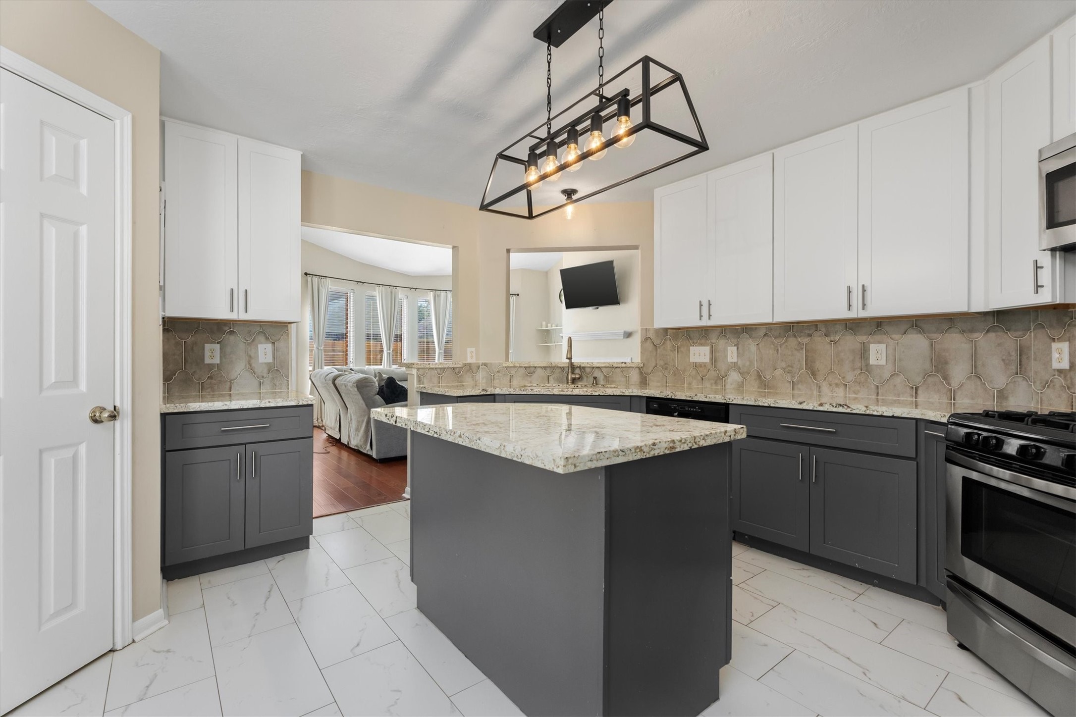 3315 La Seine Lane Spring, TX 77388 - Photo 2 of 30 a kitchen with a sink dishwasher a stove a washer and dryer