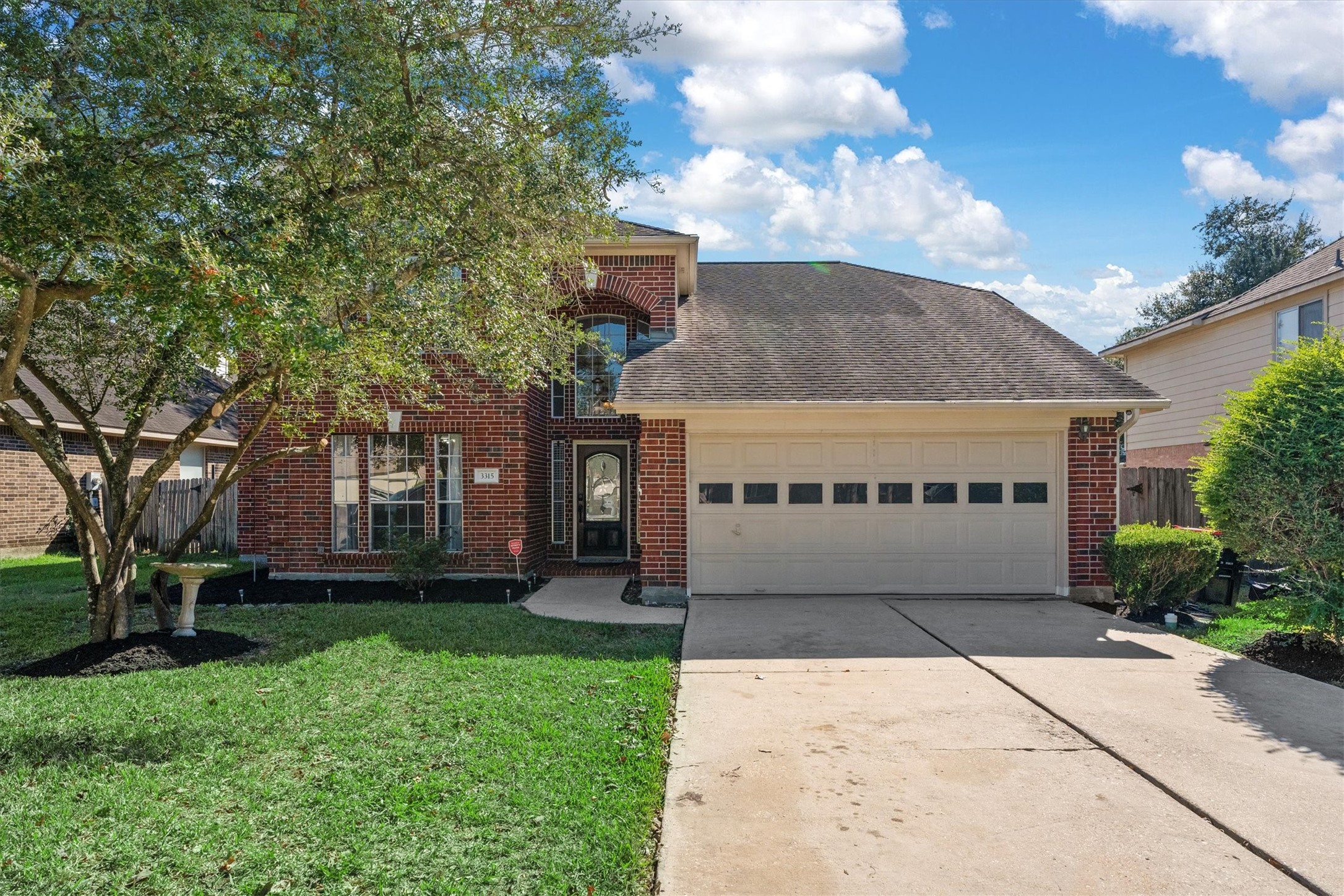 3315 La Seine Lane Spring, TX 77388 - Photo 4 of 30 a front view of a house with a garden and trees