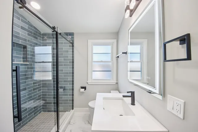 a bathroom with a sink toilet and shower