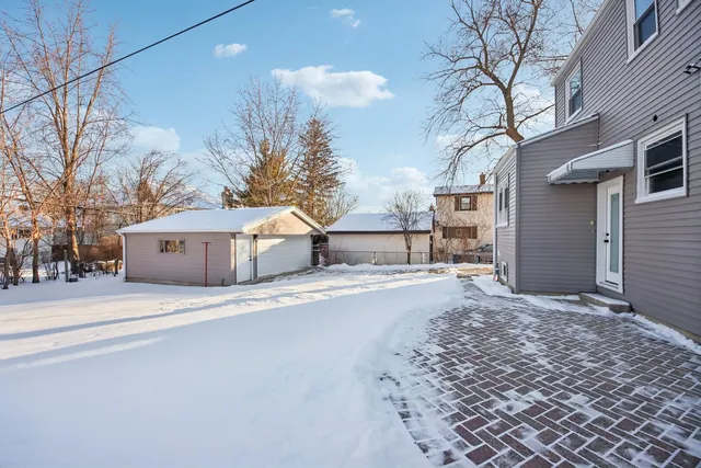 a view of a house with a snow in the yard