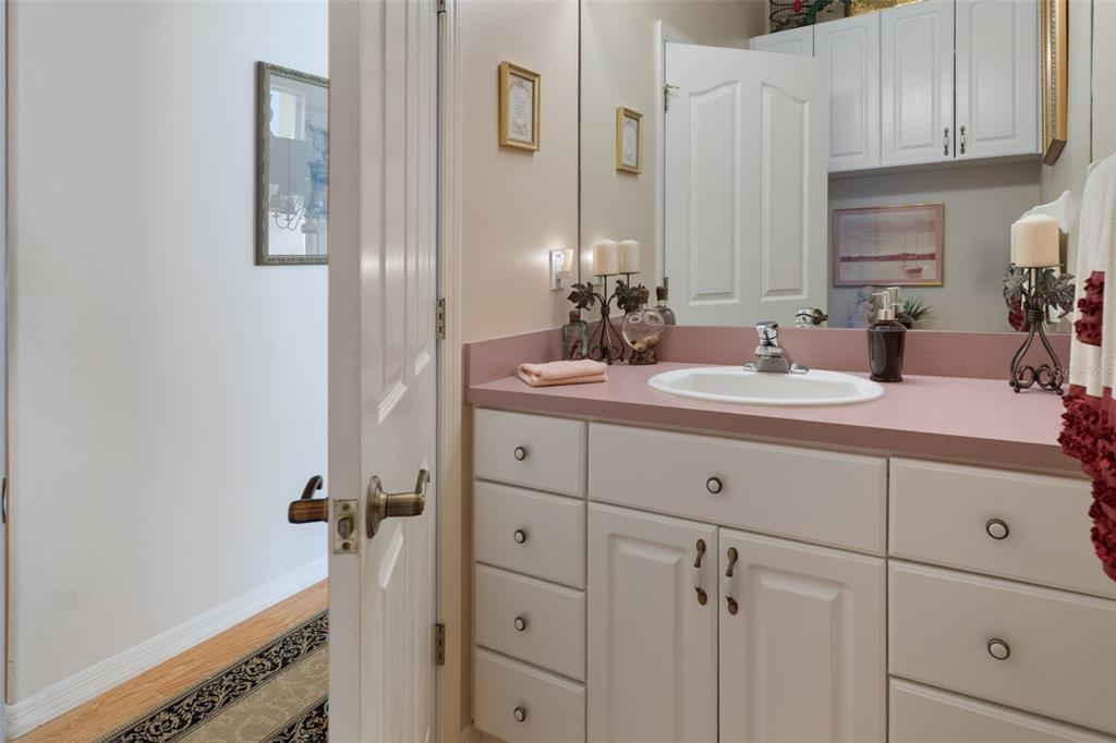 10081 Georgetown Court Weeki Wachee, FL 34613 - Photo 35 of 76 a bathroom with double sink and a mirror