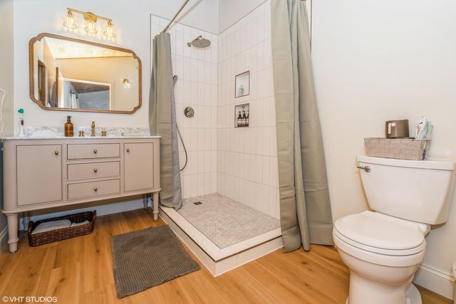 a bathroom with a toilet a sink and a mirror