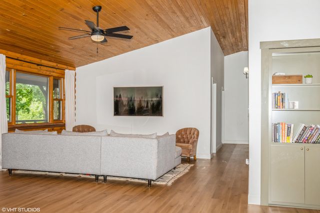 a living room with a bed furniture and a window