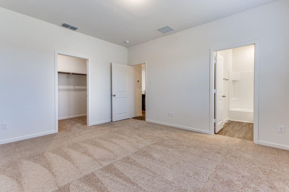 205 Briar Cove Anna, TX 75409 - Photo 6 of 11 Unfurnished bedroom featuring a spacious closet, light colored carpet, and ensuite bathroom