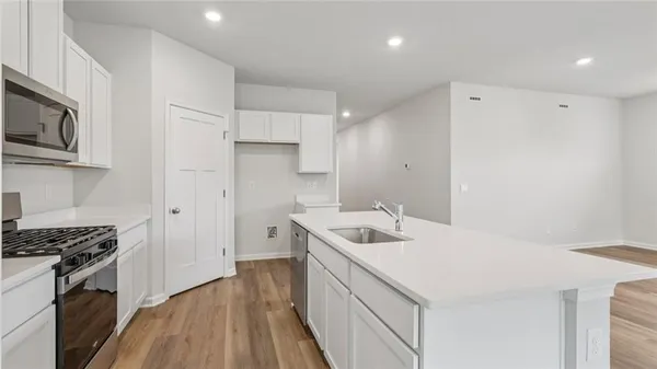 a kitchen with a sink stove and refrigerator