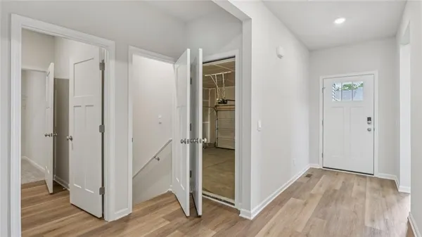 a view of empty room with wooden floor