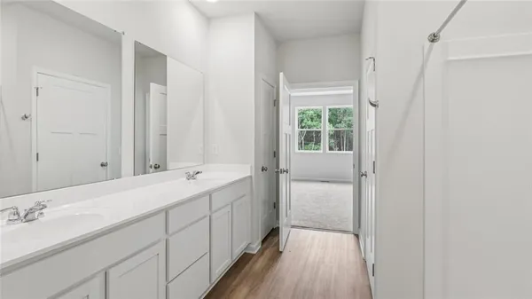 a bathroom with a double vanity sink and mirror