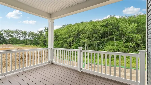 a view of a balcony with wooden floor