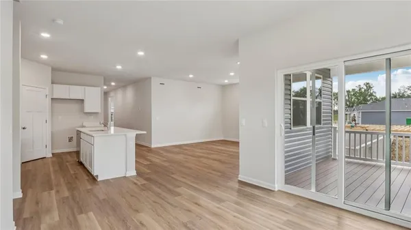 a view of a kitchen and kitchen with furniture wooden floor and windows
