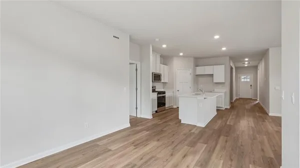 a view of a kitchen with wooden floor