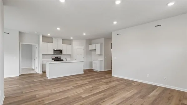 a kitchen with stainless steel appliances kitchen island wooden cabinets and granite counter tops