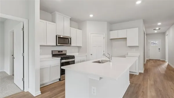 a kitchen with a sink a stove and refrigerator