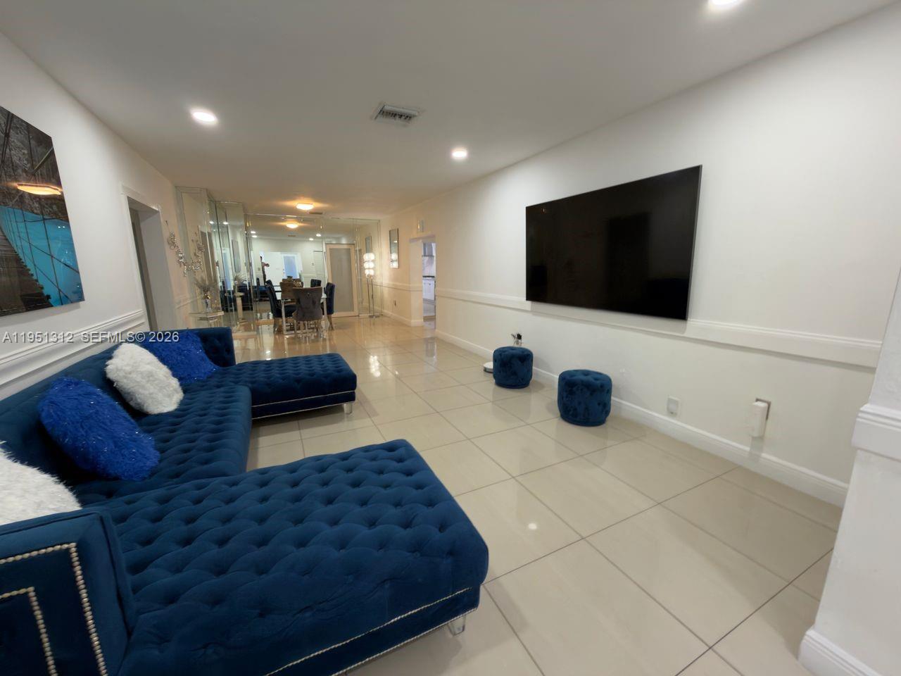 224 East 42nd Street Hialeah, FL 33013 - Photo 11 of 59 a living room with couches and a flat screen tv
