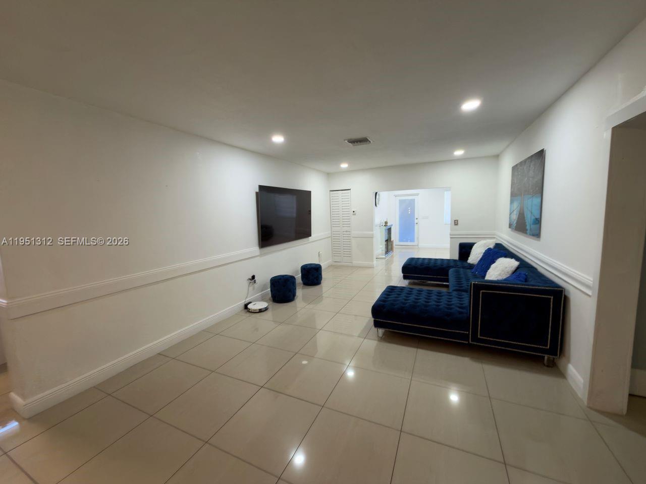 224 East 42nd Street Hialeah, FL 33013 - Photo 13 of 59 a living room with furniture and a flat screen tv