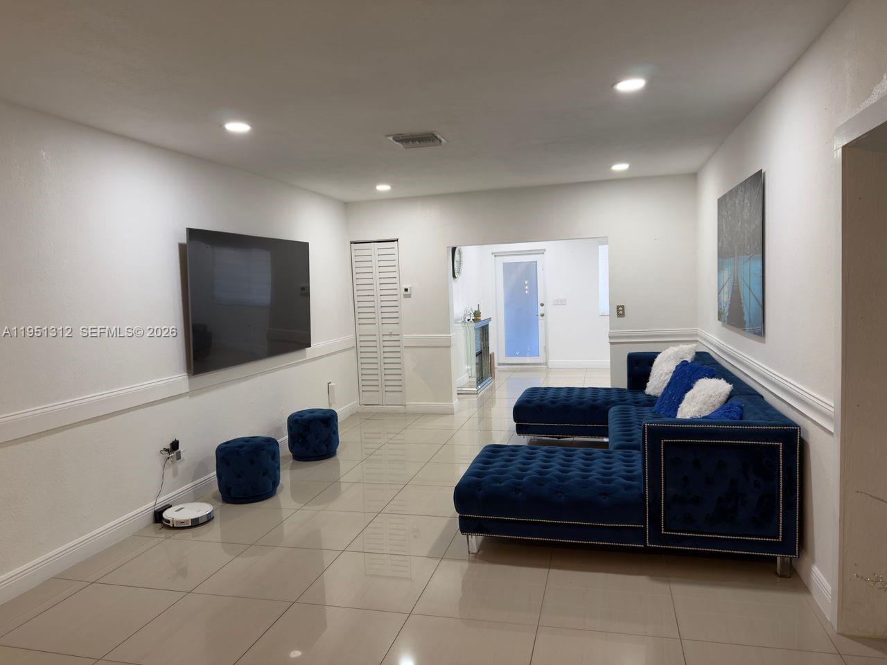 224 East 42nd Street Hialeah, FL 33013 - Photo 14 of 59 a living room with furniture and a flat screen tv