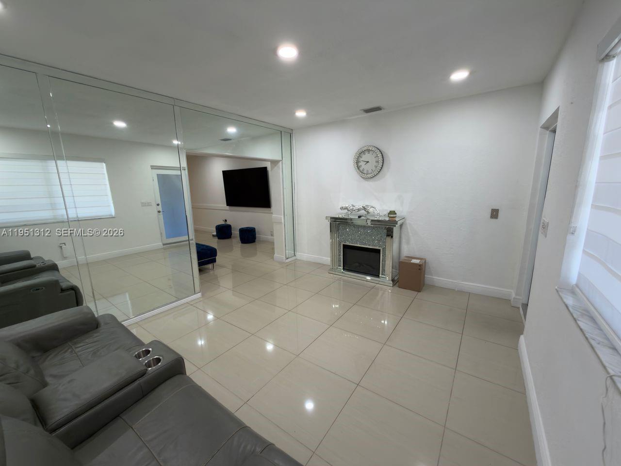 224 East 42nd Street Hialeah, FL 33013 - Photo 16 of 59 a living room with furniture and a flat screen tv
