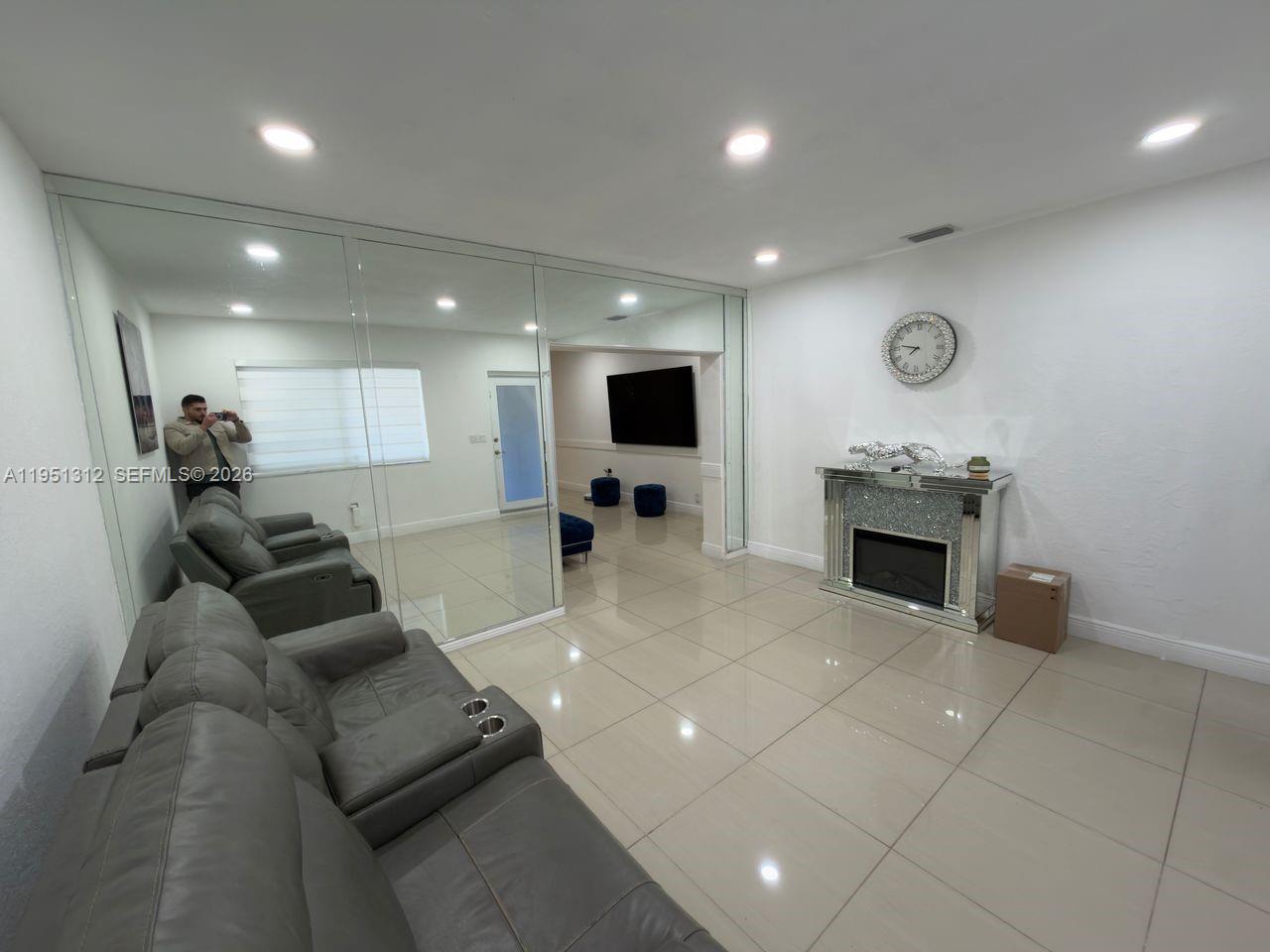 224 East 42nd Street Hialeah, FL 33013 - Photo 17 of 59 a living room with furniture and a flat screen tv