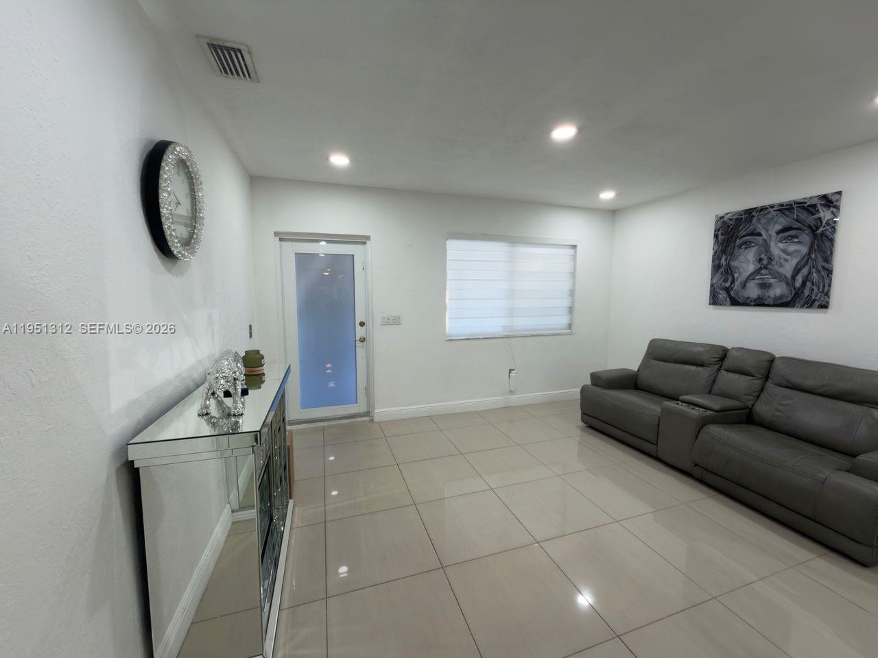 224 East 42nd Street Hialeah, FL 33013 - Photo 18 of 59 a living room with furniture and a window