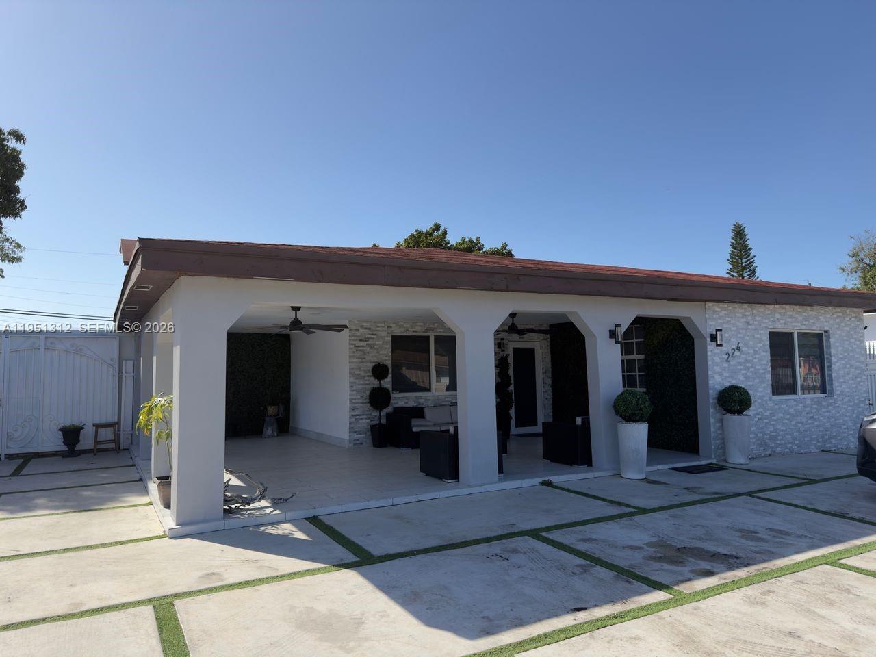 224 East 42nd Street Hialeah, FL 33013 - Photo 2 of 59 a view of a house with a porch