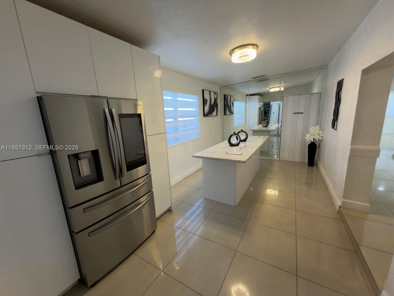 224 East 42nd Street Hialeah, FL 33013 - Photo 21 of 59 a kitchen with stainless steel appliances a refrigerator a sink a stove a microwave and cabinets