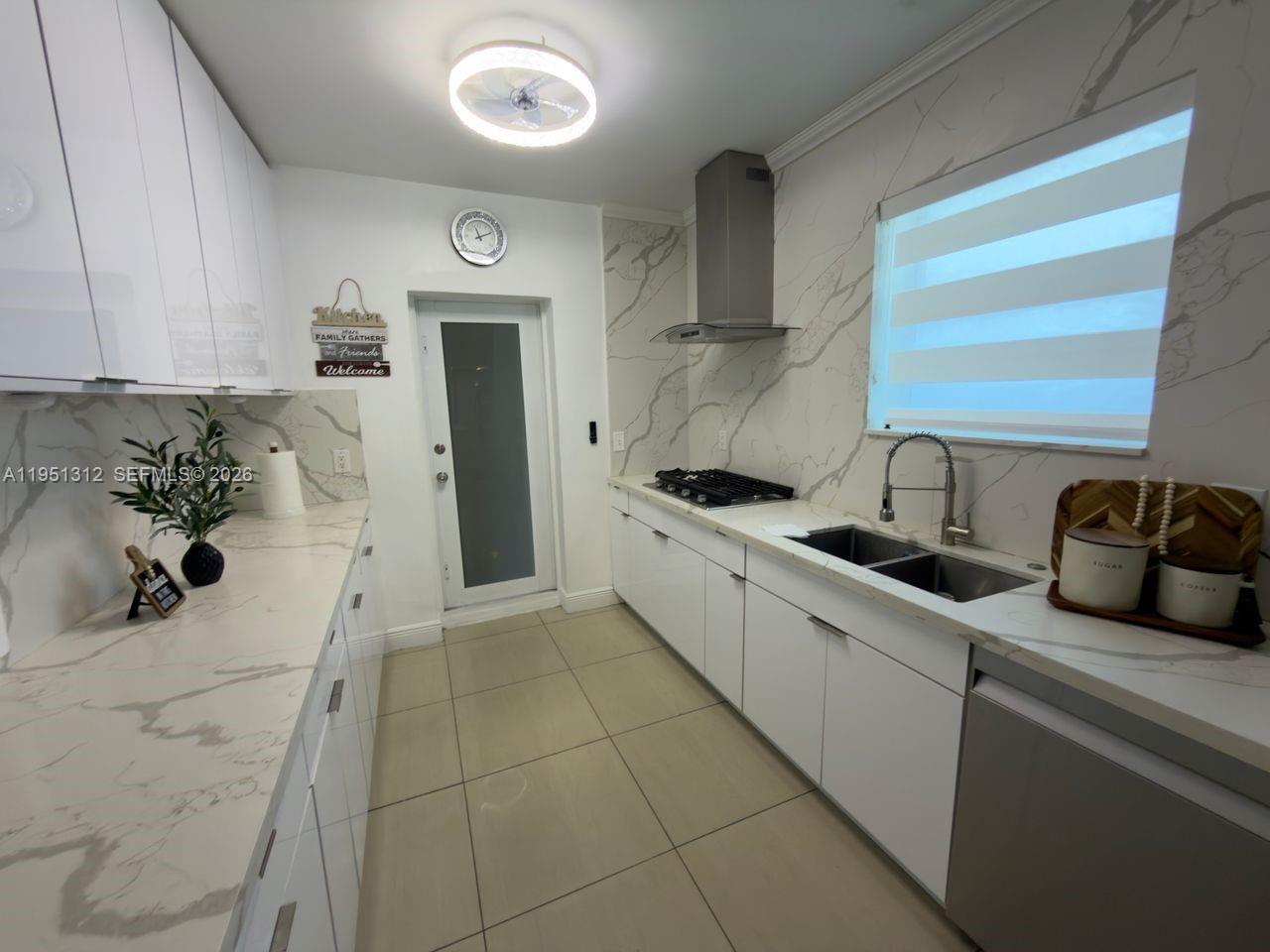 224 East 42nd Street Hialeah, FL 33013 - Photo 26 of 59 a kitchen with stainless steel appliances granite countertop a sink and cabinets