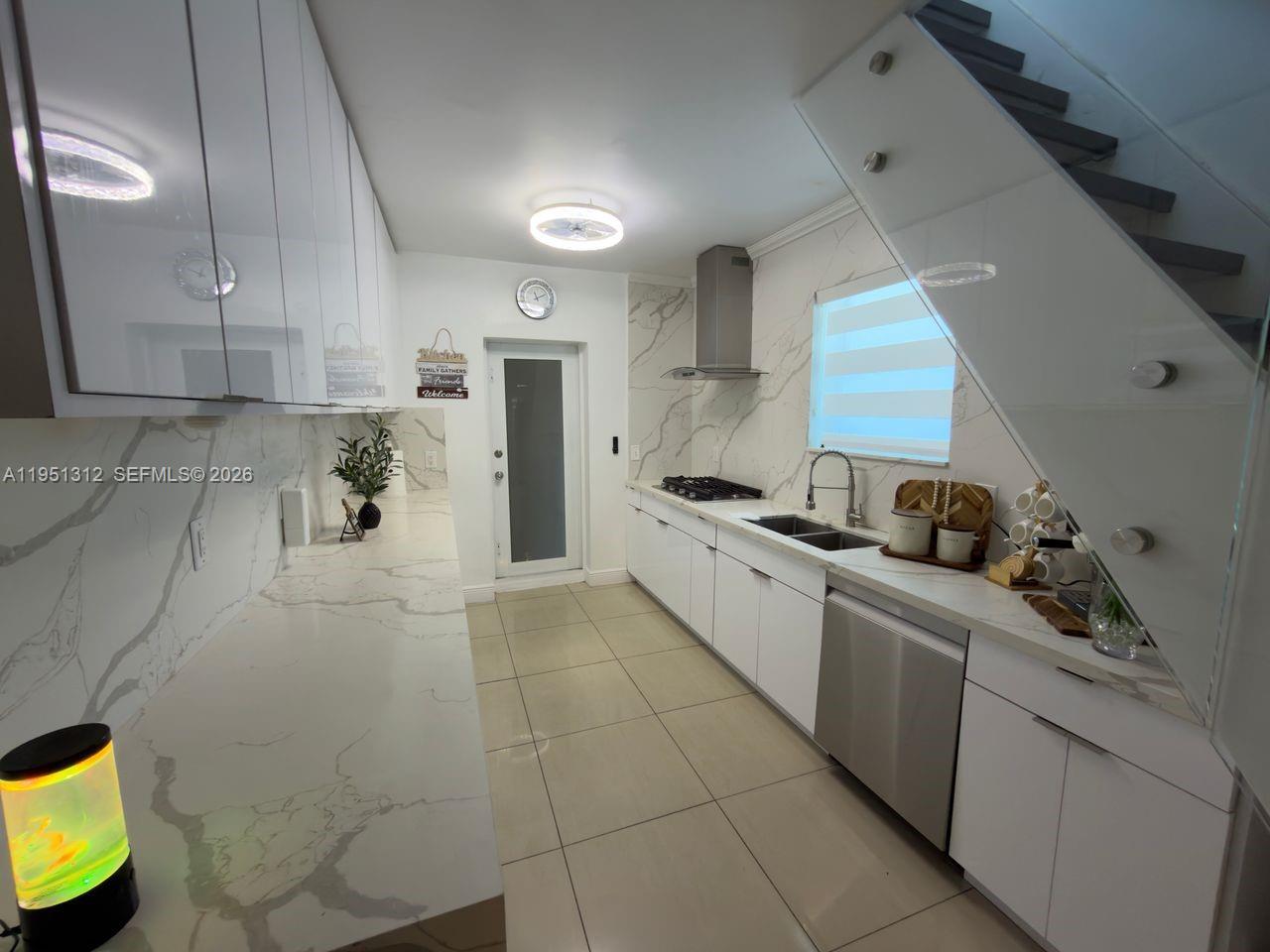 224 East 42nd Street Hialeah, FL 33013 - Photo 27 of 59 a kitchen with stainless steel appliances a sink a stove a refrigerator and cabinets