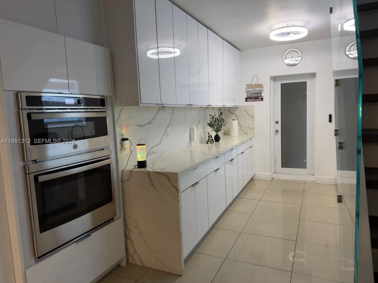 224 East 42nd Street Hialeah, FL 33013 - Photo 28 of 59 a kitchen with stainless steel appliances a stove microwave and cabinets