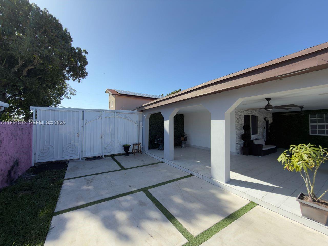224 East 42nd Street Hialeah, FL 33013 - Photo 3 of 59 a front view of a house with a yard