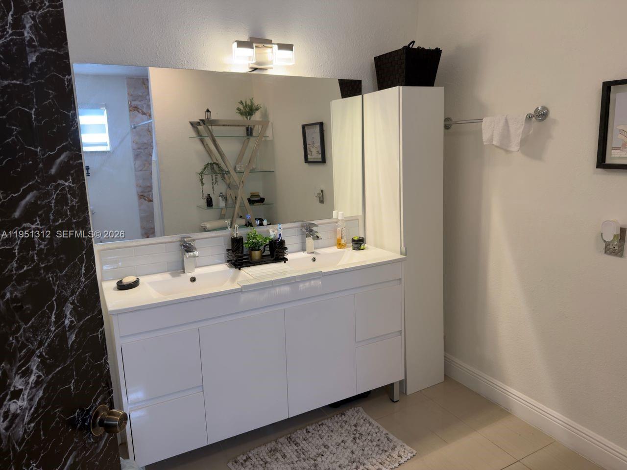 224 East 42nd Street Hialeah, FL 33013 - Photo 33 of 59 a bathroom with a double vanity sink mirror and shower