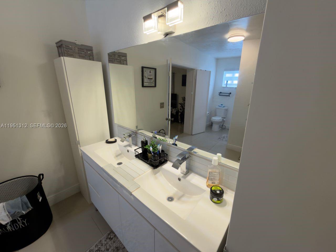 224 East 42nd Street Hialeah, FL 33013 - Photo 34 of 59 a bathroom with a sink a mirror and vanity