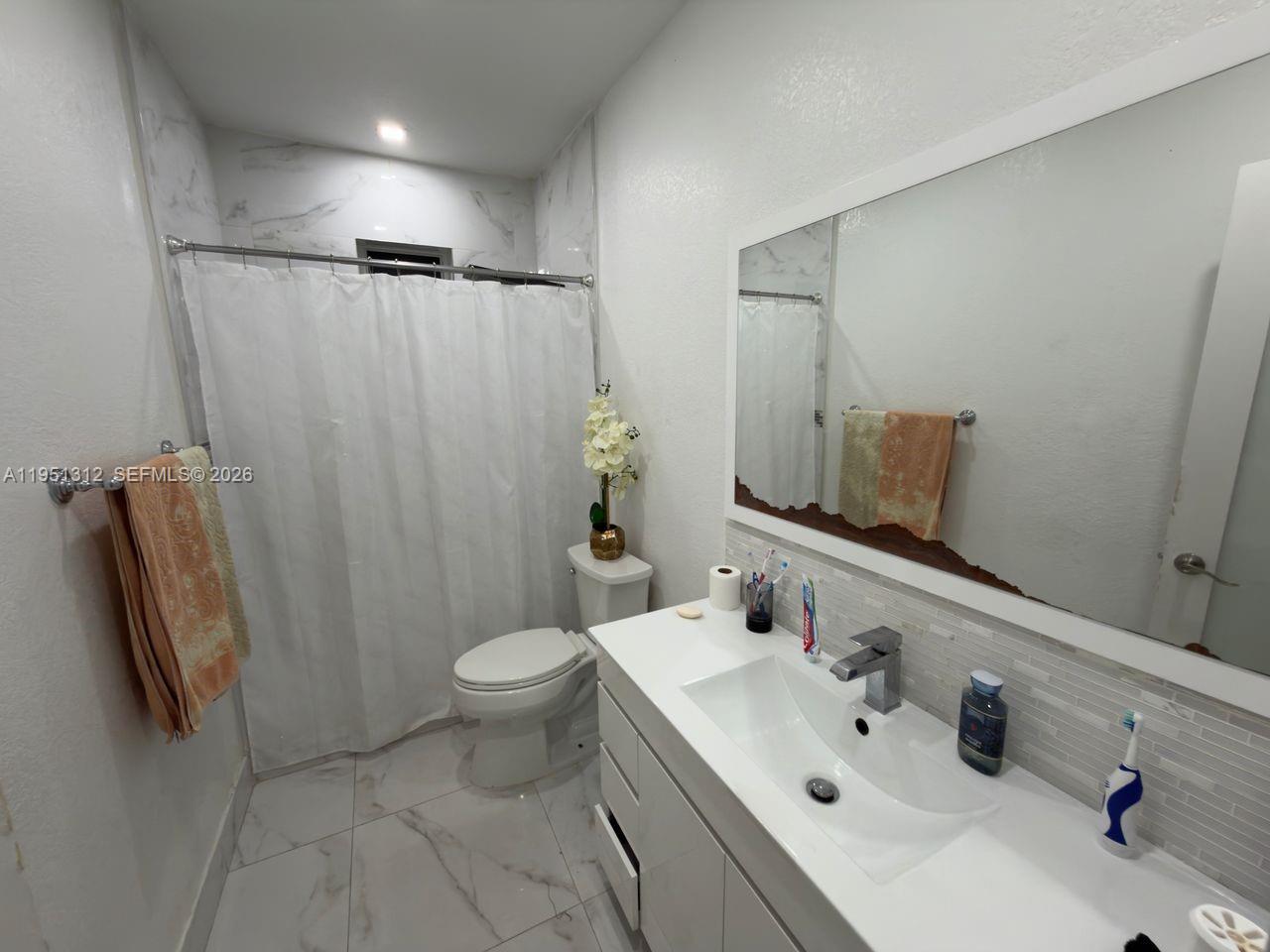 224 East 42nd Street Hialeah, FL 33013 - Photo 36 of 59 a bathroom with a sink a toilet and shower