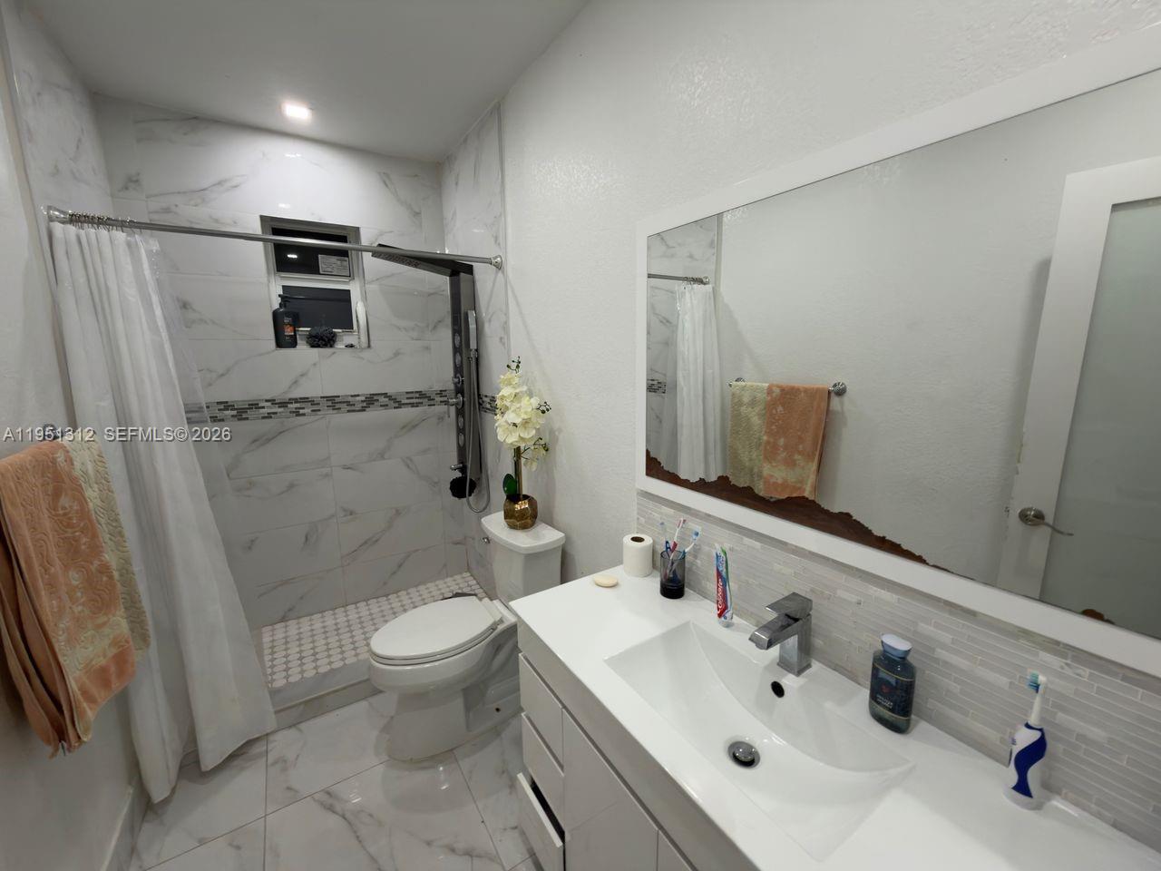 224 East 42nd Street Hialeah, FL 33013 - Photo 37 of 59 a bathroom with a sink toilet and shower