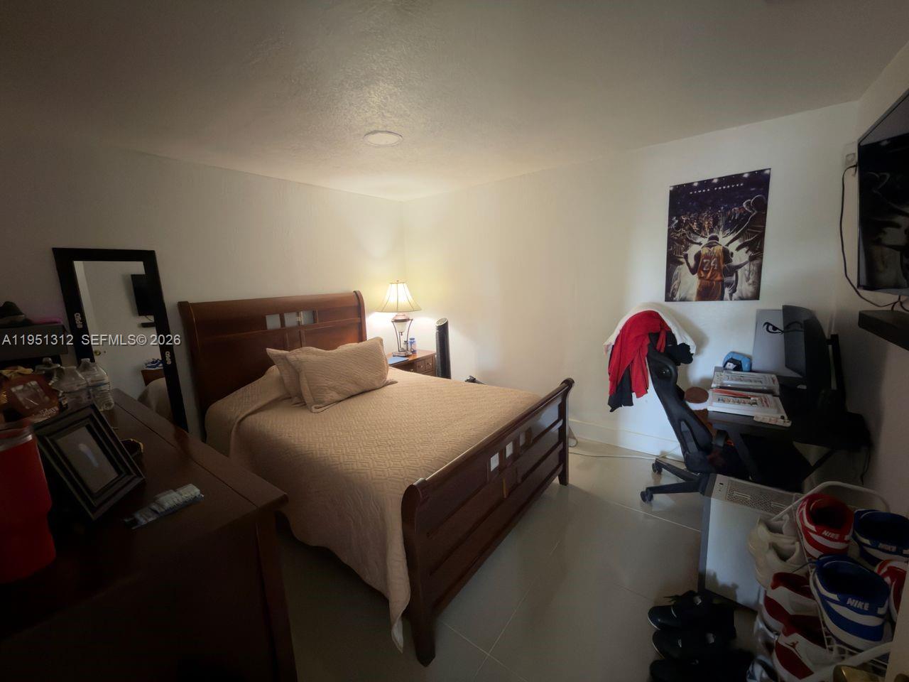 224 East 42nd Street Hialeah, FL 33013 - Photo 39 of 59 a bedroom with a bed and a chandelier