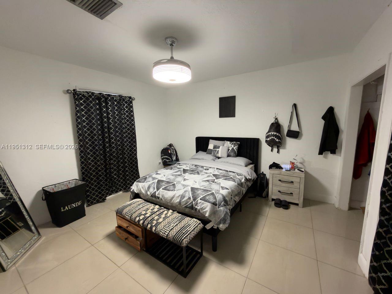 224 East 42nd Street Hialeah, FL 33013 - Photo 41 of 59 a bedroom with a bed and wooden floor