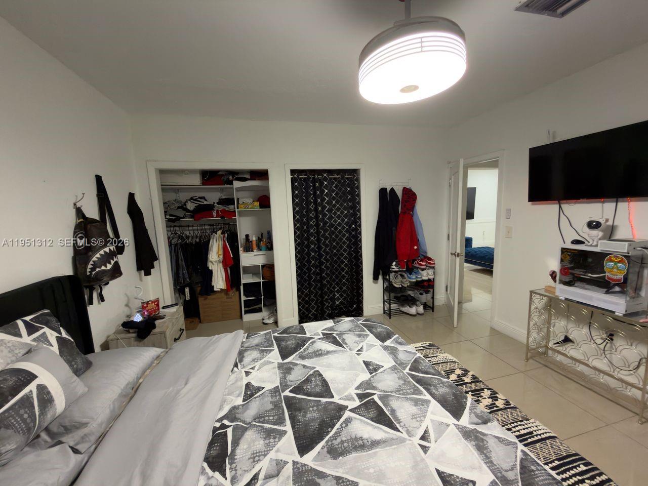 224 East 42nd Street Hialeah, FL 33013 - Photo 42 of 59 a view of a livingroom with furniture and a flat screen tv