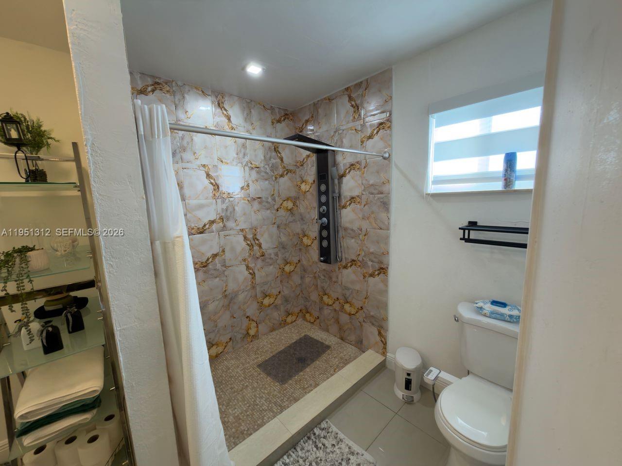 224 East 42nd Street Hialeah, FL 33013 - Photo 43 of 59 a bathroom with a shower a toilet and sink