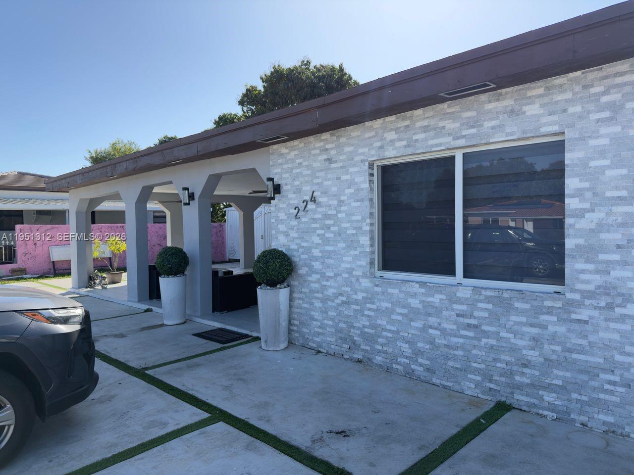 224 East 42nd Street Hialeah, FL 33013 - Photo 9 of 59 a front view of a house with a yard