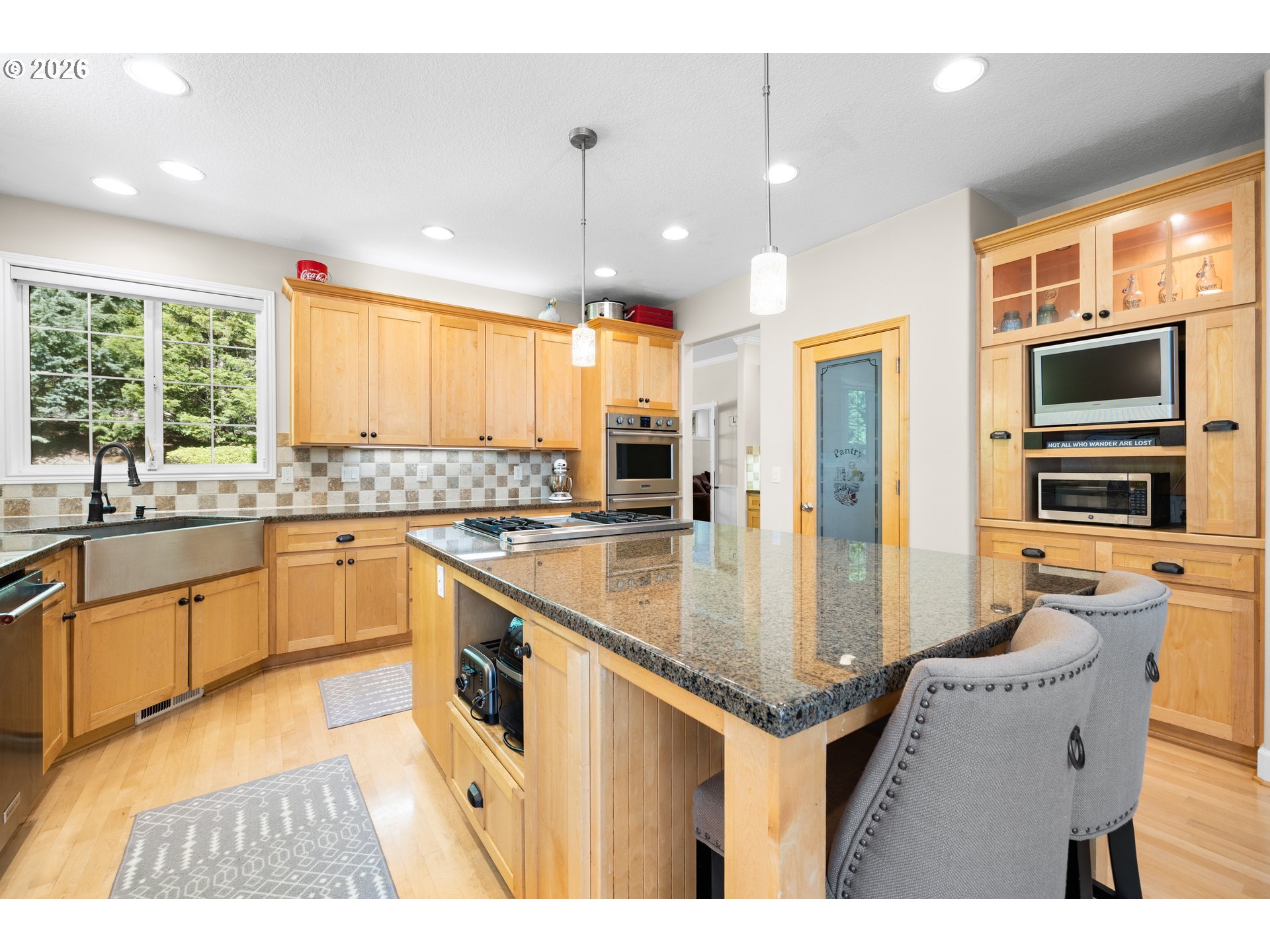2633 Southeast Vista Way Gresham, OR 97080 - Photo 13 of 48 a kitchen with stainless steel appliances granite countertop a sink and dishwasher a refrigerator with wooden floor