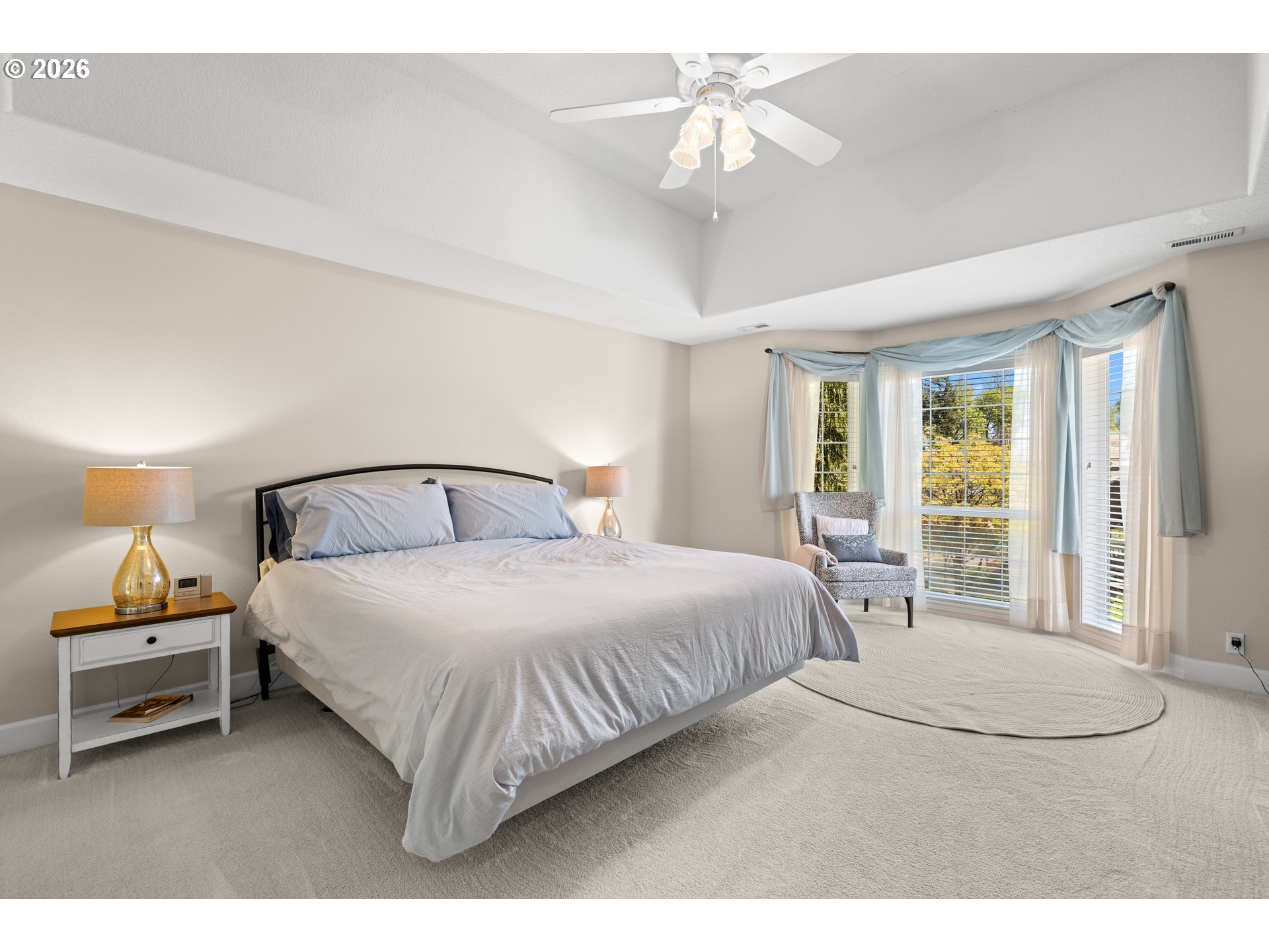 2633 Southeast Vista Way Gresham, OR 97080 - Photo 22 of 48 a bedroom with a large bed and a chandelier