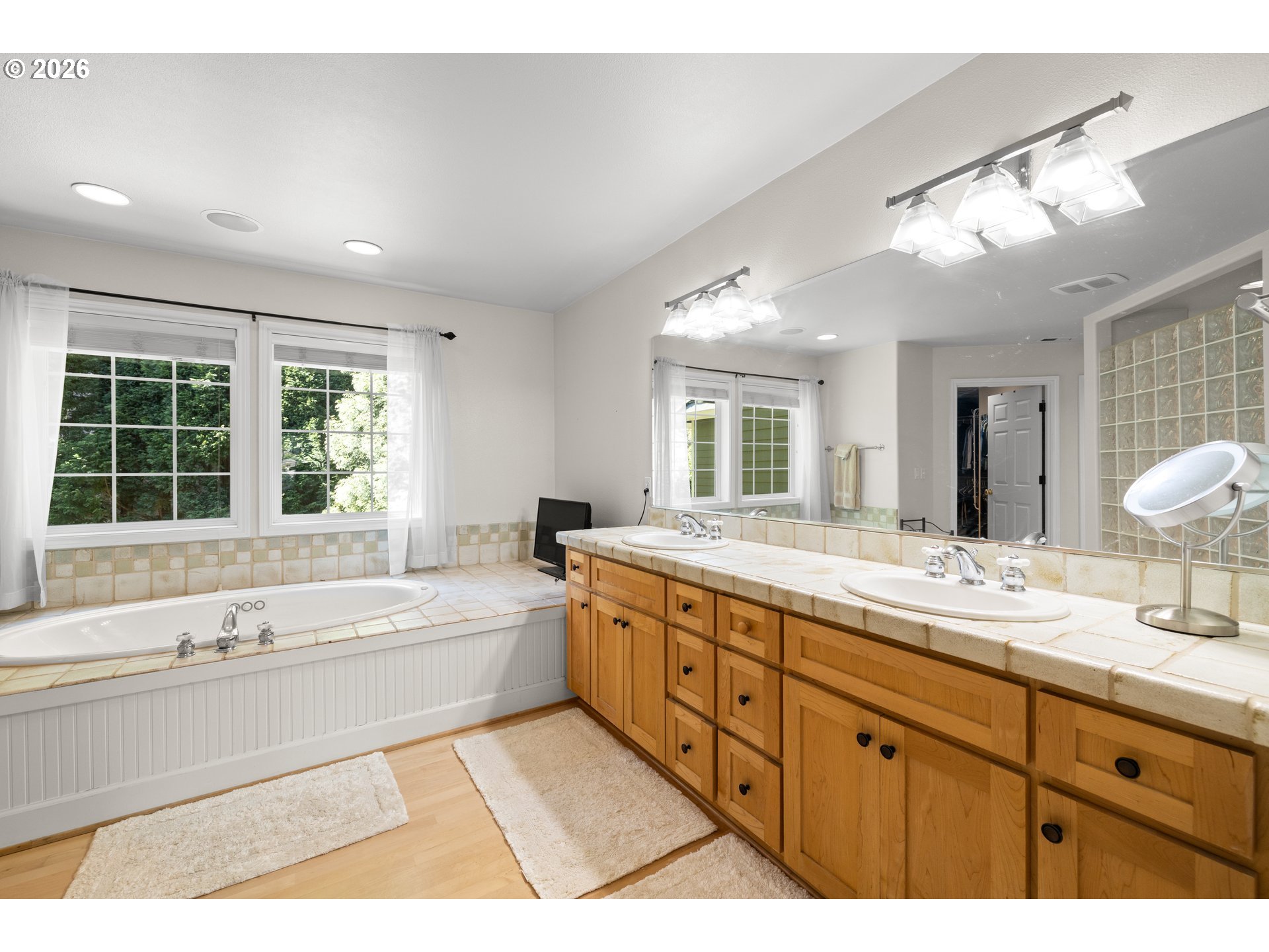 2633 Southeast Vista Way Gresham, OR 97080 - Photo 23 of 48 a spacious bathroom with a large tub sink and mirror