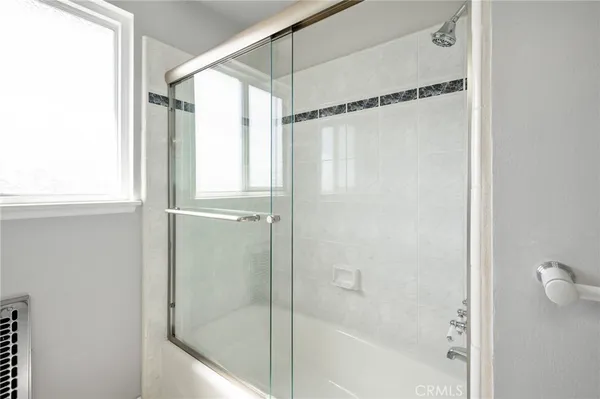 a bathroom with a glass shower door