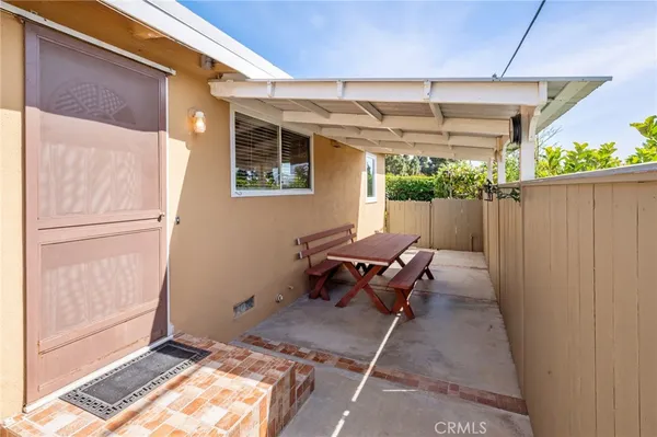 a view of a patio with couches and potted plants