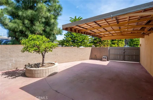 a patio with a table and chairs under an umbrella