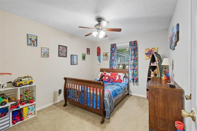 a bedroom with furniture a baby crib and a couch